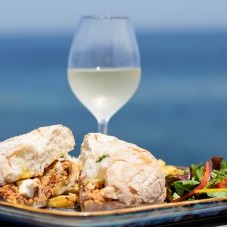 Maltese tuna ftira with a glass of white wine