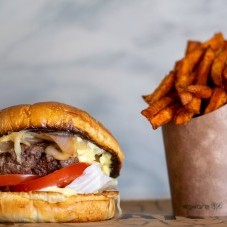 Beef burger with cheese, tomatoes, lettuce and sweet potato fries
