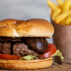 Beef burger with shiitake mushrooms, tomatoes, lettuce and fries