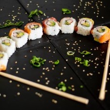 Rainbow sushi rolls placed in the shape of a fan