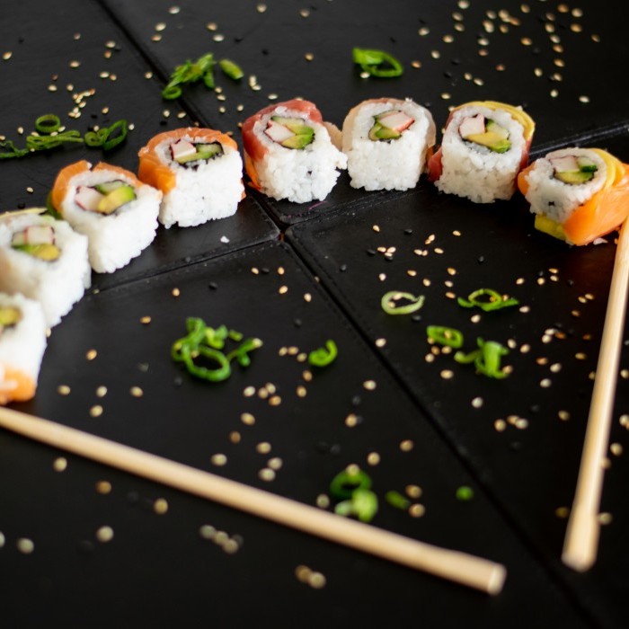 Rainbow sushi rolls placed in the shape of a fan