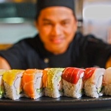 Sakura's Chef serving rainbow sushi rolls