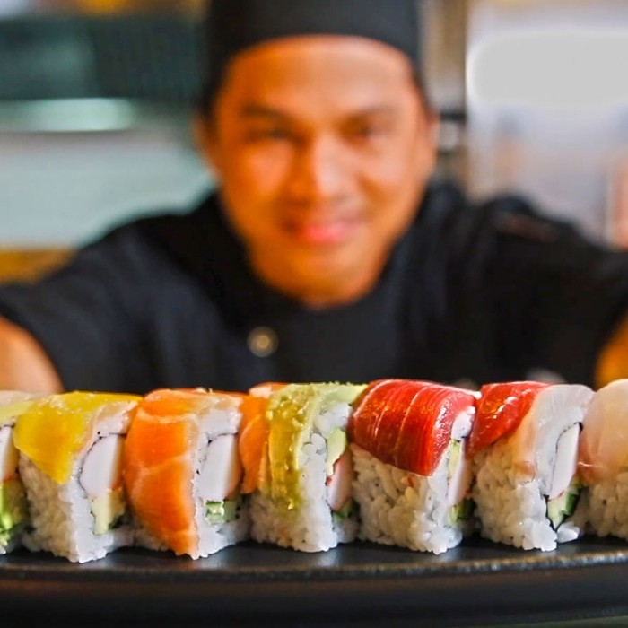 Sakura's Chef serving rainbow sushi rolls