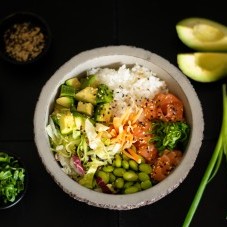 Poke bowl with salmon, avocado, edamame beans and rice 