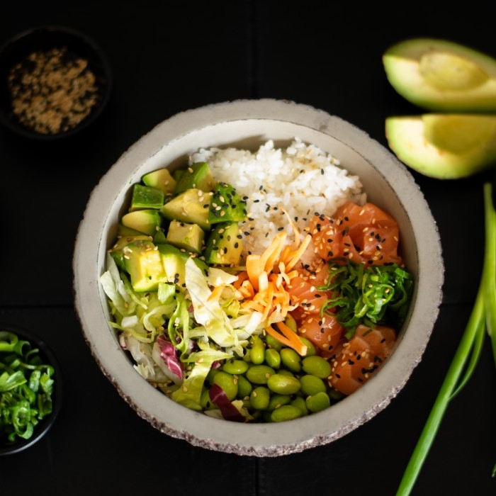 Poke bowl with salmon, avocado, edamame beans and rice 